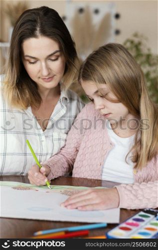 woman kid drawing together close up