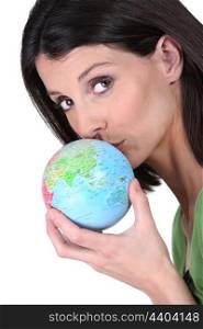 Woman kissing globe