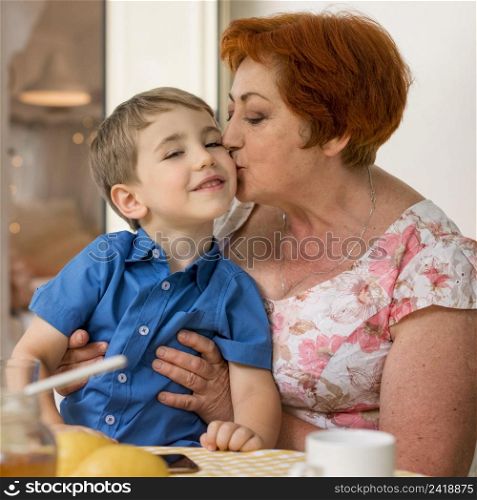 woman kissing her grandson cheek