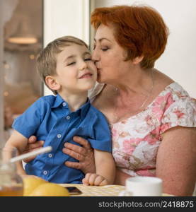 woman kissing her grandson cheek