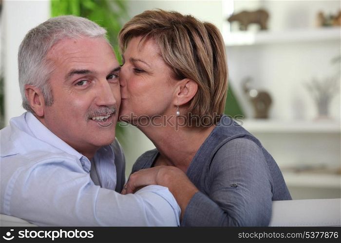 Woman kissing her husband