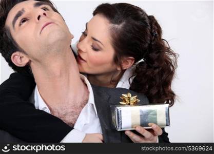Woman kissing her partner for a present