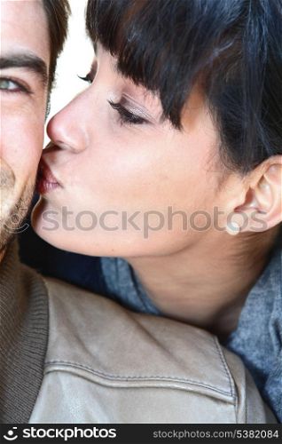 Woman kissing man