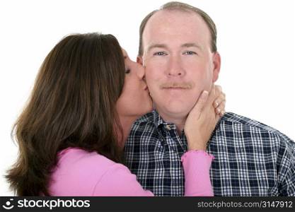 Woman kissing man on cheek.