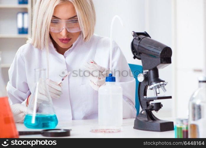 Woman lab analyst working on new drugs