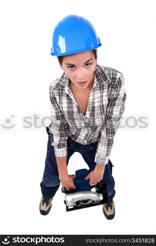 Woman laborer carrying heavy sander