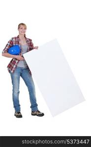 Woman laborer holding white board