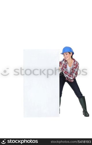 Woman laborer showing white board for message