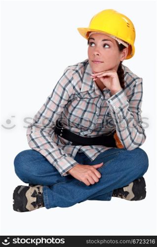 Woman laborer sitting on the ground