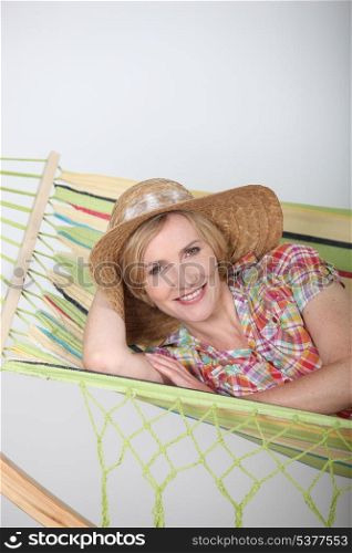 Woman laid in hammock relaxing