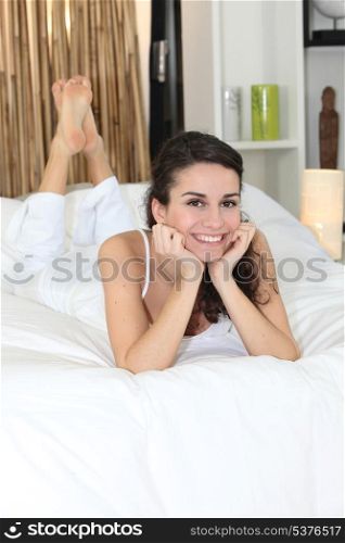 Woman laid on a bed