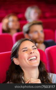 woman laughing in cinema audience