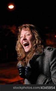 woman laughs on night street