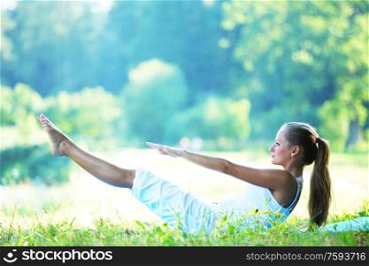 woman lay and training on ground yoga outdoors. sport on the groud