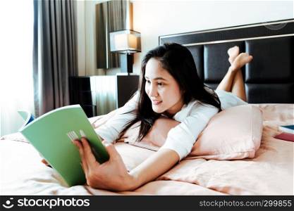 woman lay on bed reading the blank book