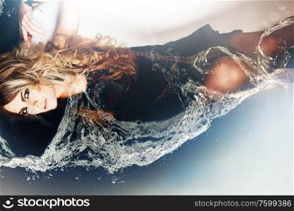 woman laying in bath with water