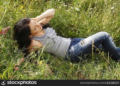 Woman laying in tall grass