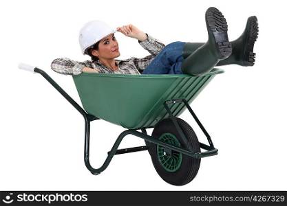 Woman laying in wheelbarrow