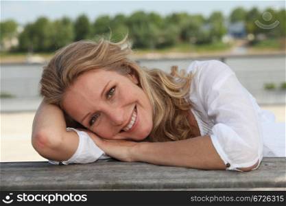Woman laying on jetty
