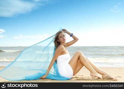 woman laying on sand sea on background