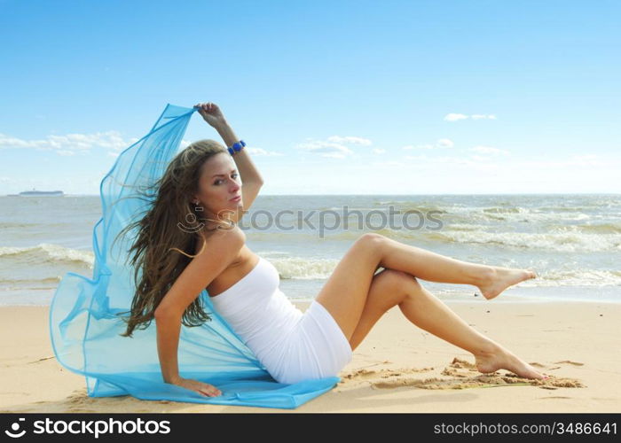 woman laying on sand sea on background