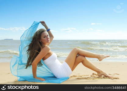 woman laying on sand sea on background