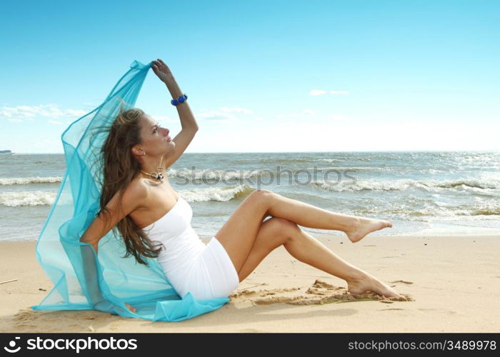 woman laying on sand sea on background