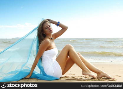 woman laying on sand sea on background