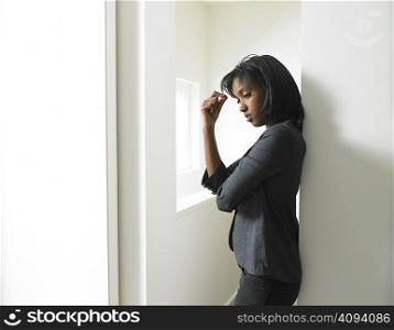Woman leaning against a wall