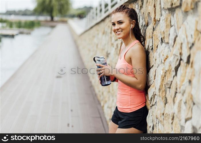 woman leaning against stone wall