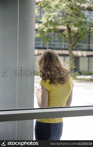Woman leaning against window