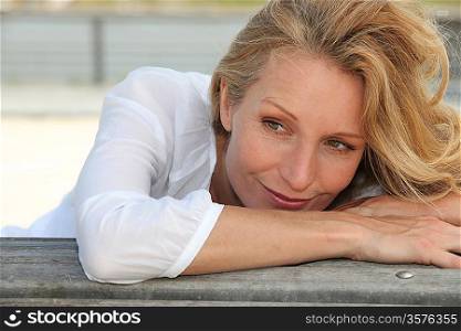 Woman leaning on a bench