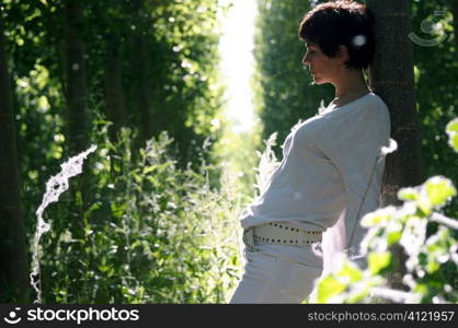 Woman leaning on a tree