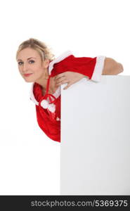 Woman leaning on blank poster