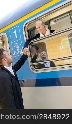 Woman leaving with train man farewell couple smiling travel commuter