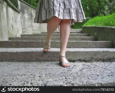 Woman legs going down the stair way