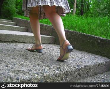 Woman legs going up the stair way
