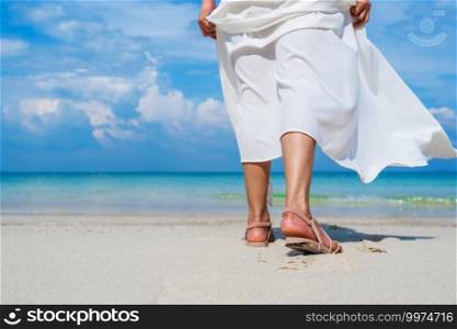 woman legs walking on the sea beach at Koh MunNork Island, Rayong, Thailand