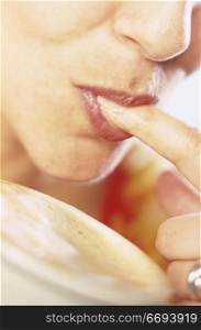 Woman Licking Foam off of Finger