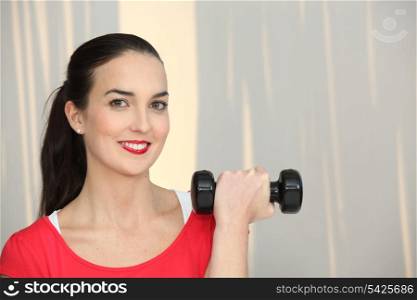 Woman lifting a dumbbell