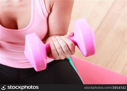 Woman lifting dumbbell . Woman lifting dumbbell. Young girl exercising in gym. Health workout fitness concept.