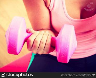 Woman lifting dumbbell. Young girl exercising in gym. Health workout fitness concept. . Woman lifting dumbbell