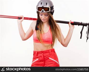 Woman lifting skiing poles. Young skier girl wearing helmet goggles. Winter sport lifestlye relax fitness concept. . Woman lifting skiing poles.