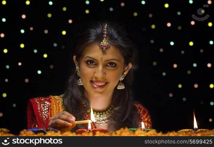 Woman lighting Diya