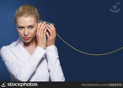 Woman Listening on Tin Can Phone
