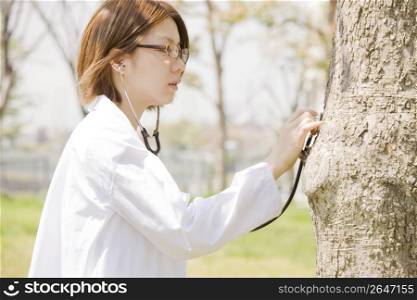 woman listening to a tree