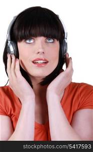 woman listening to music against studio background