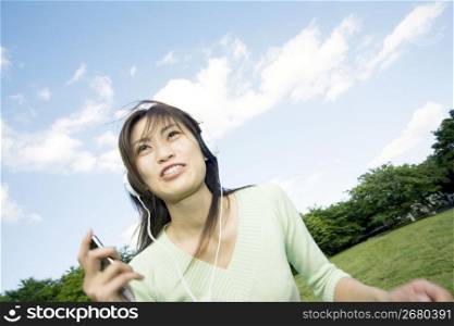 Woman listening to music in the park