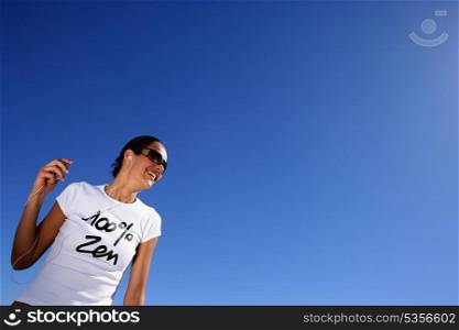 Woman listening to music in the sun