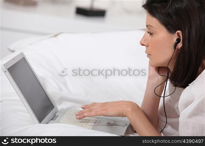 Woman listening to music through earphones
